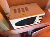 a microwave that is sitting on top of a cabinet