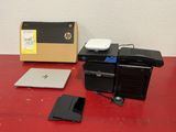 a laptop, a hard drive, and a hard drive on a red table