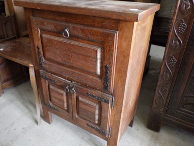 a wooden cabinet with a drawer on top of it