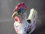 porcelain figurine of a rooster on a gray background
