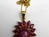 a close up of a necklace on a white surface
