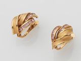 a pair of gold and diamond ear clips