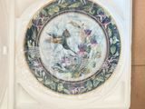 a plate with a picture of a bird on it in a box