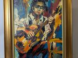 un tableau représentant un homme jouant de la guitare, dans un cadre doré