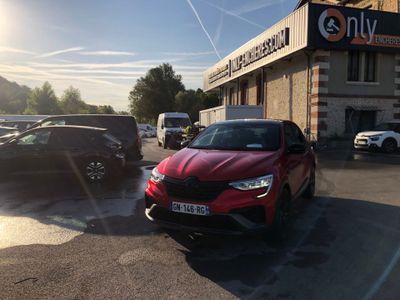 a red car parked in front of a building