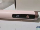 a pink electric toothbrush sitting next to a box of toothpaste