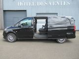 a black van with its doors open in a parking lot