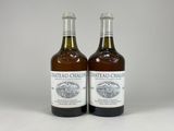 two bottles of wine sitting next to each other on a table