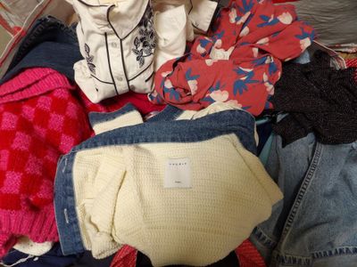a suitcase full of clothes that is sitting on the floor