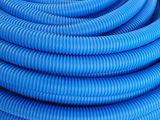 a close up of a blue hose on a white surface