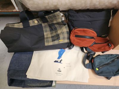 a pile of luggage sitting on the floor next to a couch