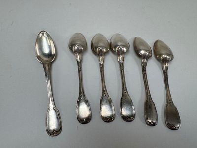six silver spoons are lined up in a row on a table
