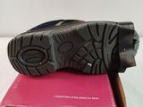 the shoe is sitting on top of a pink box on a bed