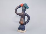 figurine of a man with a hat on his head and hands on his hips