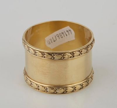 an 18k gold napkin ring