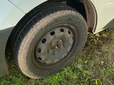a white car with a flat tire parked on the grass