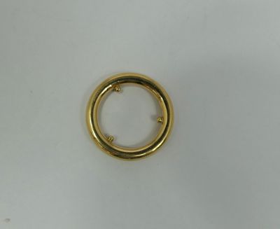 a close up of a gold ring on a white surface