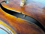 a close up of a violin that has a hole in the back of it