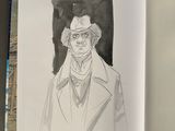 an open book with a drawing of a man in a hat and coat
