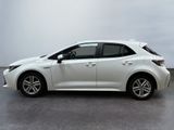 a white toyota corollant parked in a room with a white wall