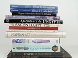 many books stacked on top of each other on a table