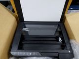 a printer that is sitting in a box on the floor