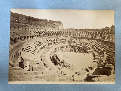 an old black and white photo of an arena with people in it