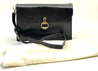 LANCEL. Pochette de soirée en cuir noir, bijouterie en métal…