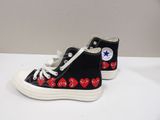 black converse sneakers with hearts on them on a white surface