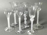 six wine glasses sitting next to each other on a table