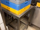 a metal table with a blue and yellow tray on top of it
