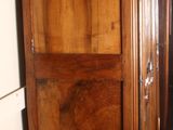 a large wooden cabinet in the corner of a room