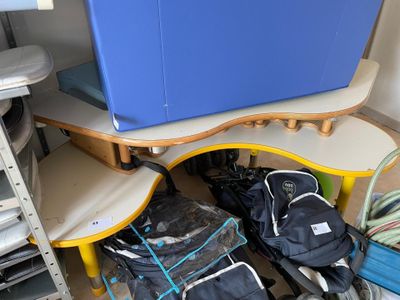 many bags of luggage sitting on the floor next to a table