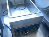 a large fryer sitting on a table in a kitchen
