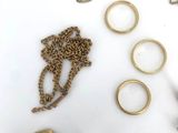 a lot of gold jewelry on a white surface
