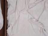a box with a white shirt inside of it on the floor