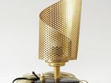 a gold lamp with a black base and a white cord