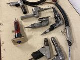 many different types of airbrushes and tools laid out on a table