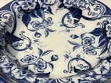 a blue and white plate with a bird on it