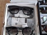 many pairs of glasses sitting in a box on a table