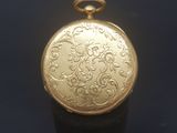 an image of a close up of a gold locke on a black surface
