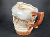 a coffee cup with a handle on a table