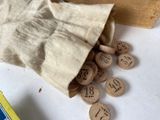 a bag full of wooden numbers on a table