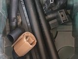 a green trash can filled with different types of pipes