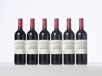 six bottles of red wine lined up in a row