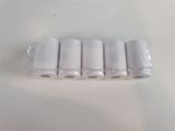 six rolls of toilet paper are wrapped in plastic on a white surface
