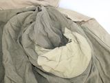 a pile of clothes that is laying on a bed