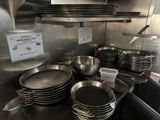many pots and pans on the counter in the kitchen