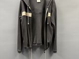 a grey jacket hanging on a hanger on a wall