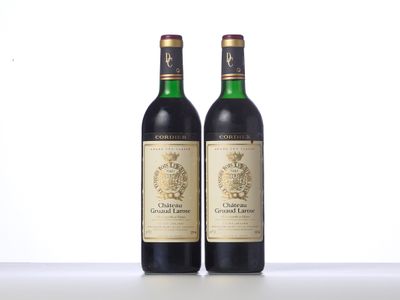 two bottles of wine sit side by side on a table